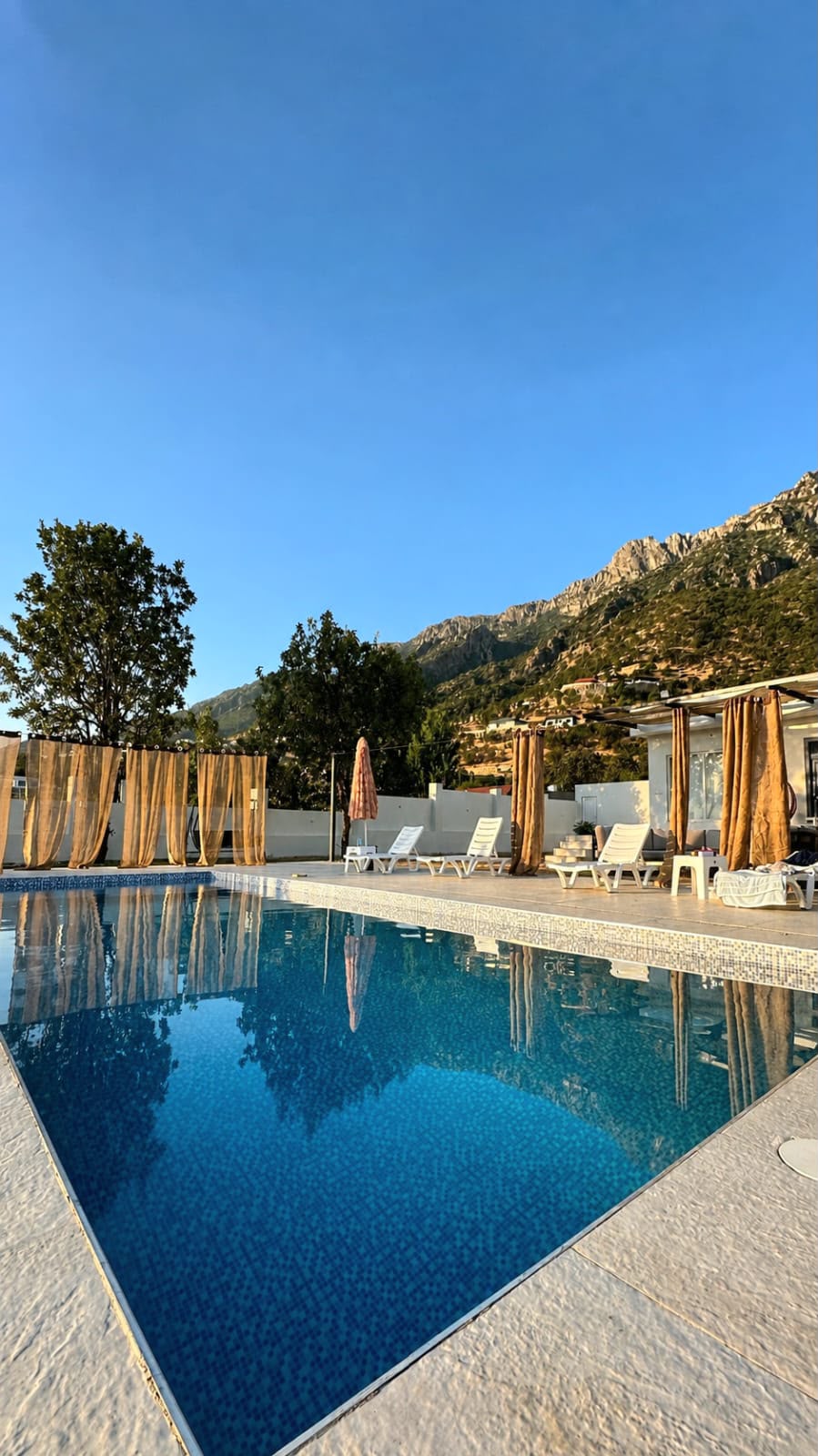 Pool and Shaqlawa mountain ridge in morning light
